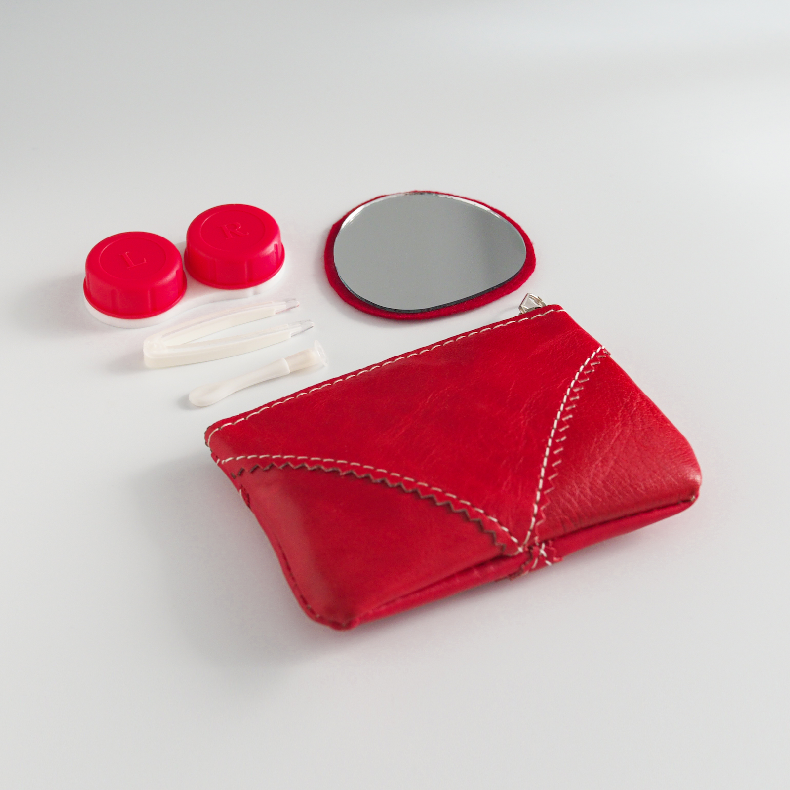 Estuche lentillero de pie con cremallera en color rojo y kit de lentillas completo